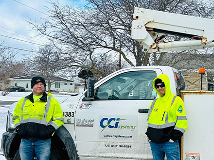 CCI Technical Field Services Workers standing by CCI truck