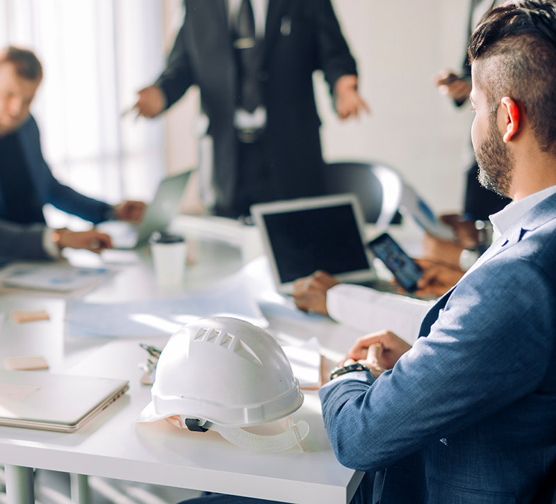 Consultants sitting around a table consulting system assessments Consultants sitting around a table consulting system assessments