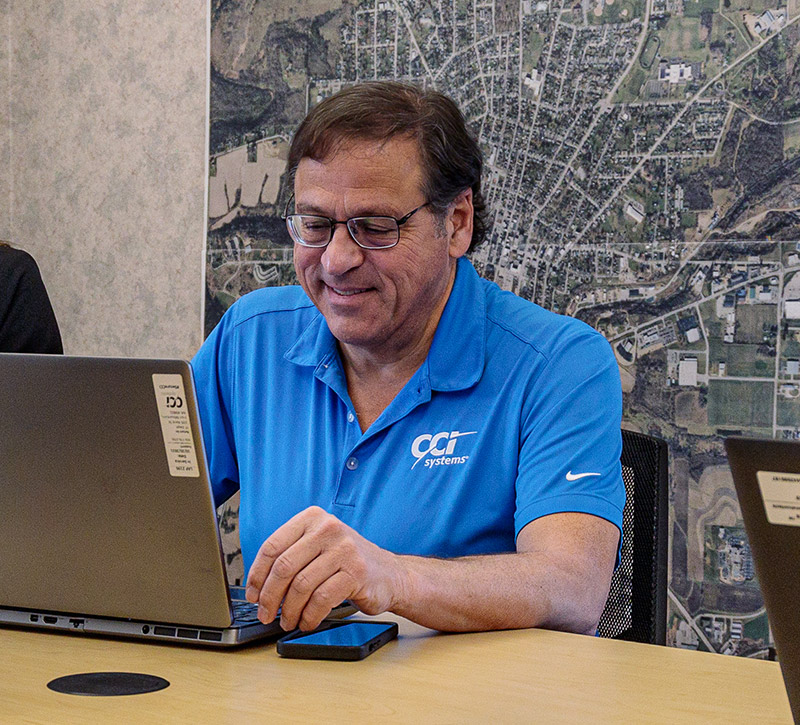 CCI Asset Management Worker On Laptop