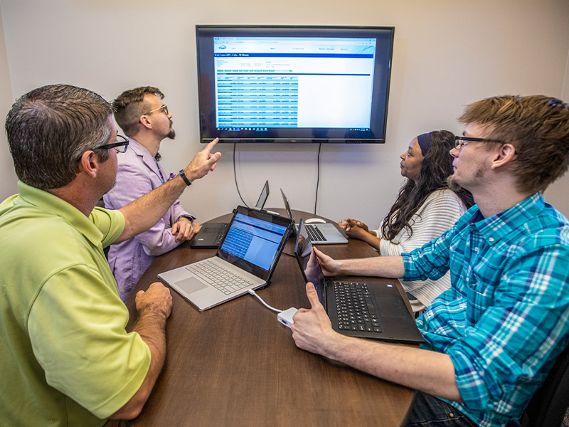 CCI Team Consulting On Laptop Together